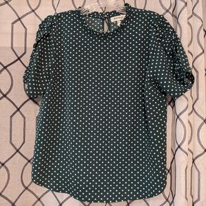 Green and white polka dot blouse